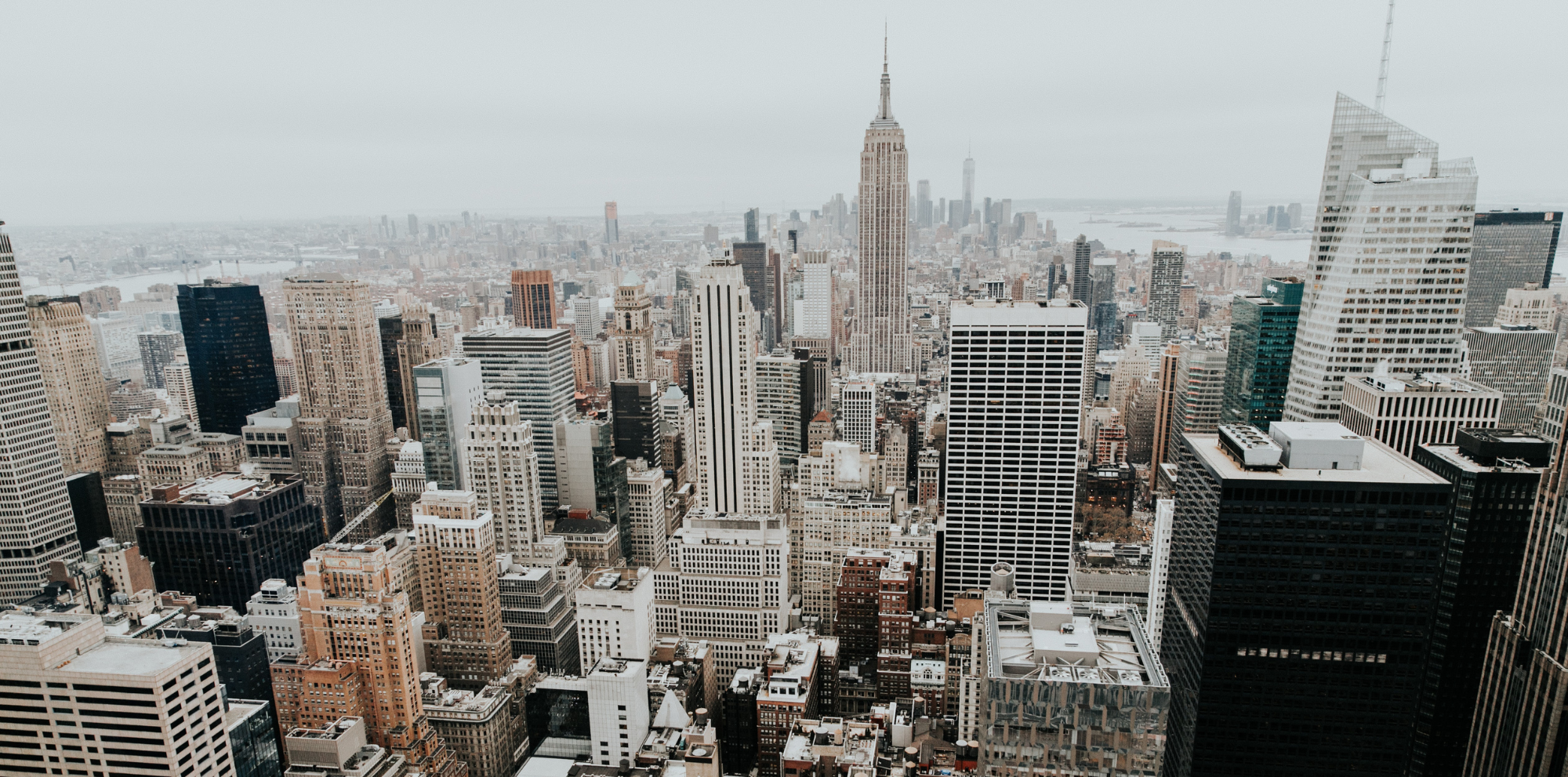 Shopify Markets vs Expansion stores, featured image of a high-rise city skyline